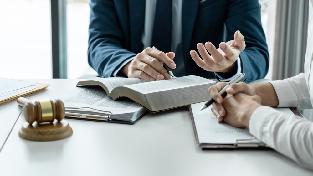 Male,Lawyer,Is,Pointing,On,Legal,Document,To,Explaining,About
